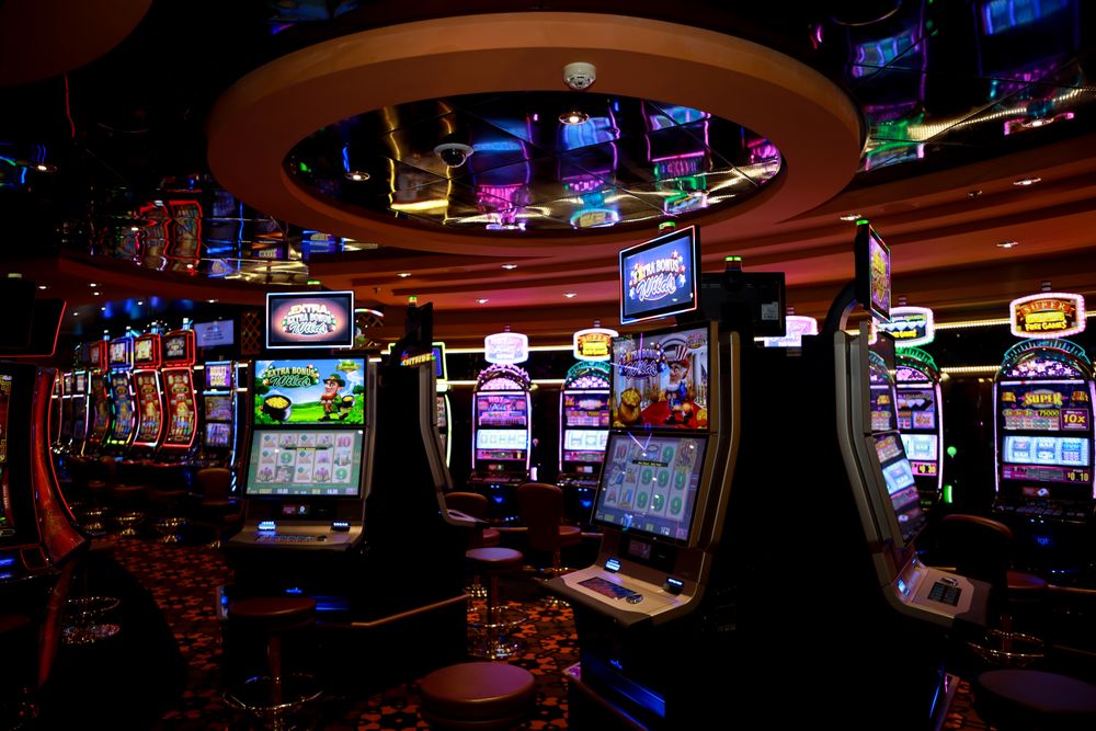 Suasana lantai kasino dengan mesin slot yang menyala